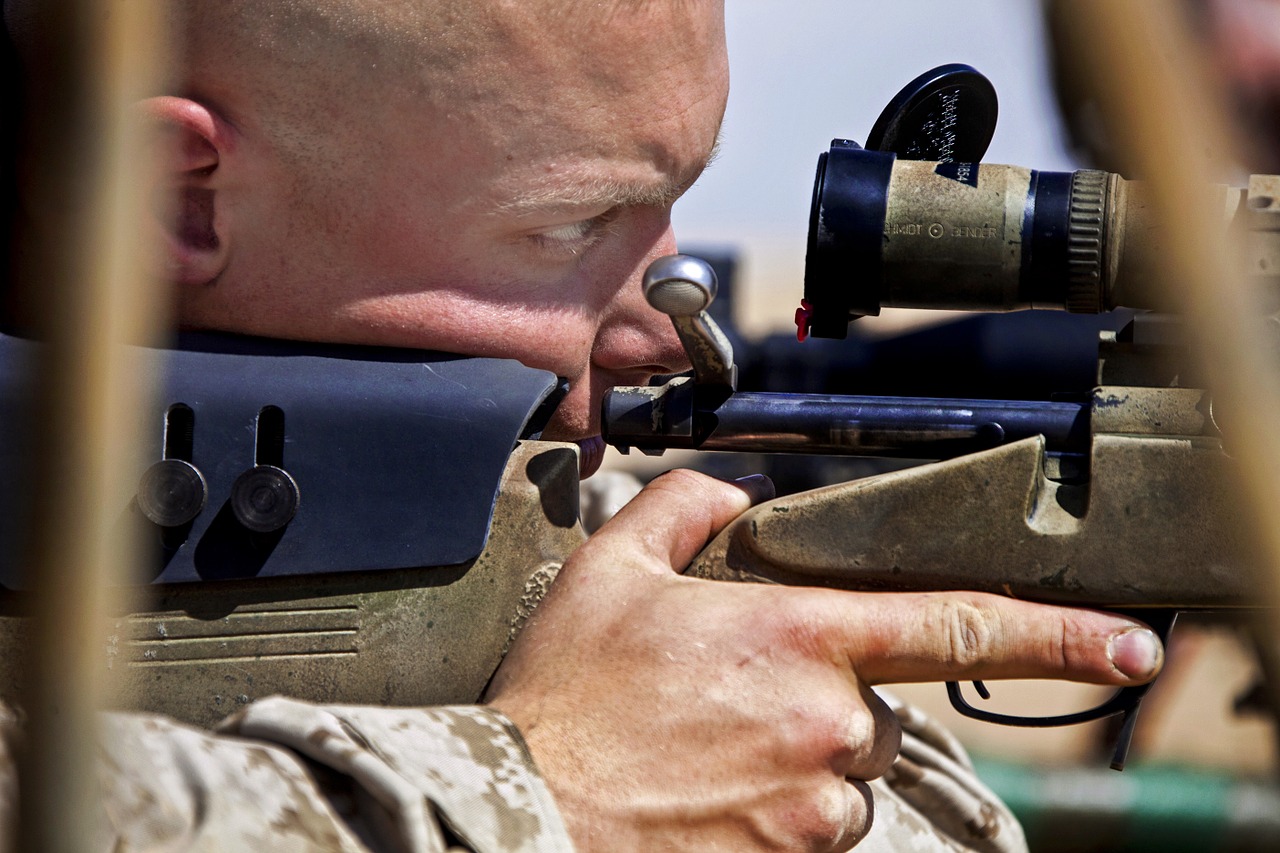 a soldier looking through one of the first focal plane scopes